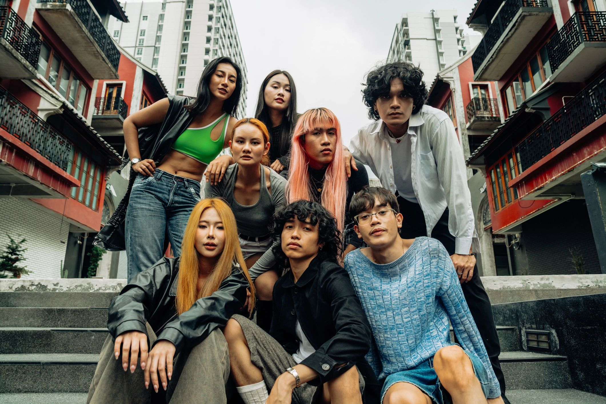 Fashion-forward creative team posing together in an urban-inspired setting